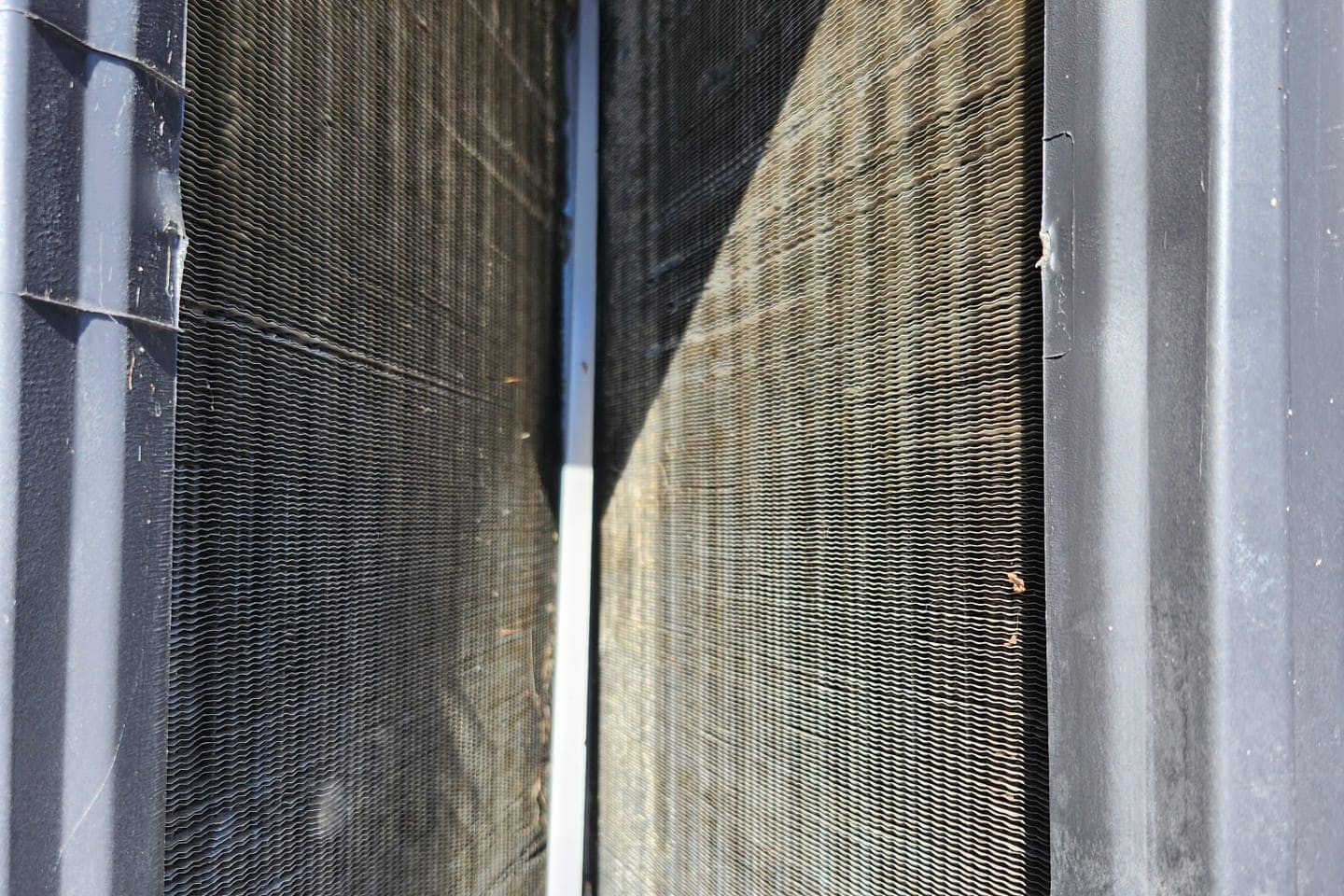 The fins of an outdoor condenser coil up close.