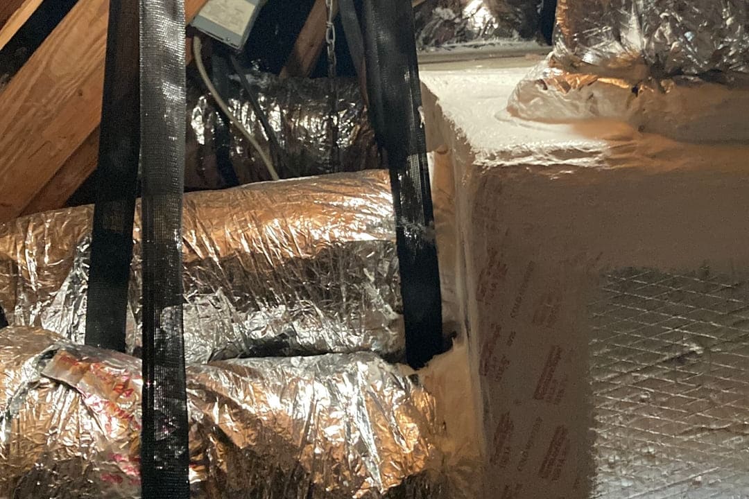 Insulated flexible duct running through an attic.