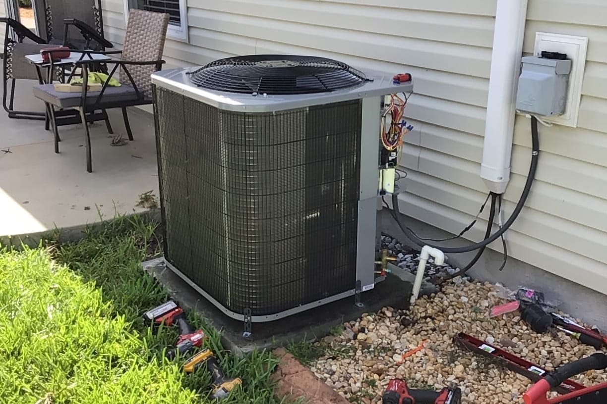 An outdoor condenser beside a patio on a Florida home.