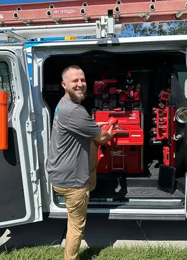 AC technician getting tools out of suncoast air conditioning llc van